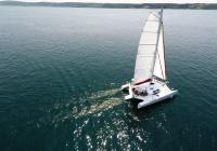 trimaran sailing sun reflection at sea